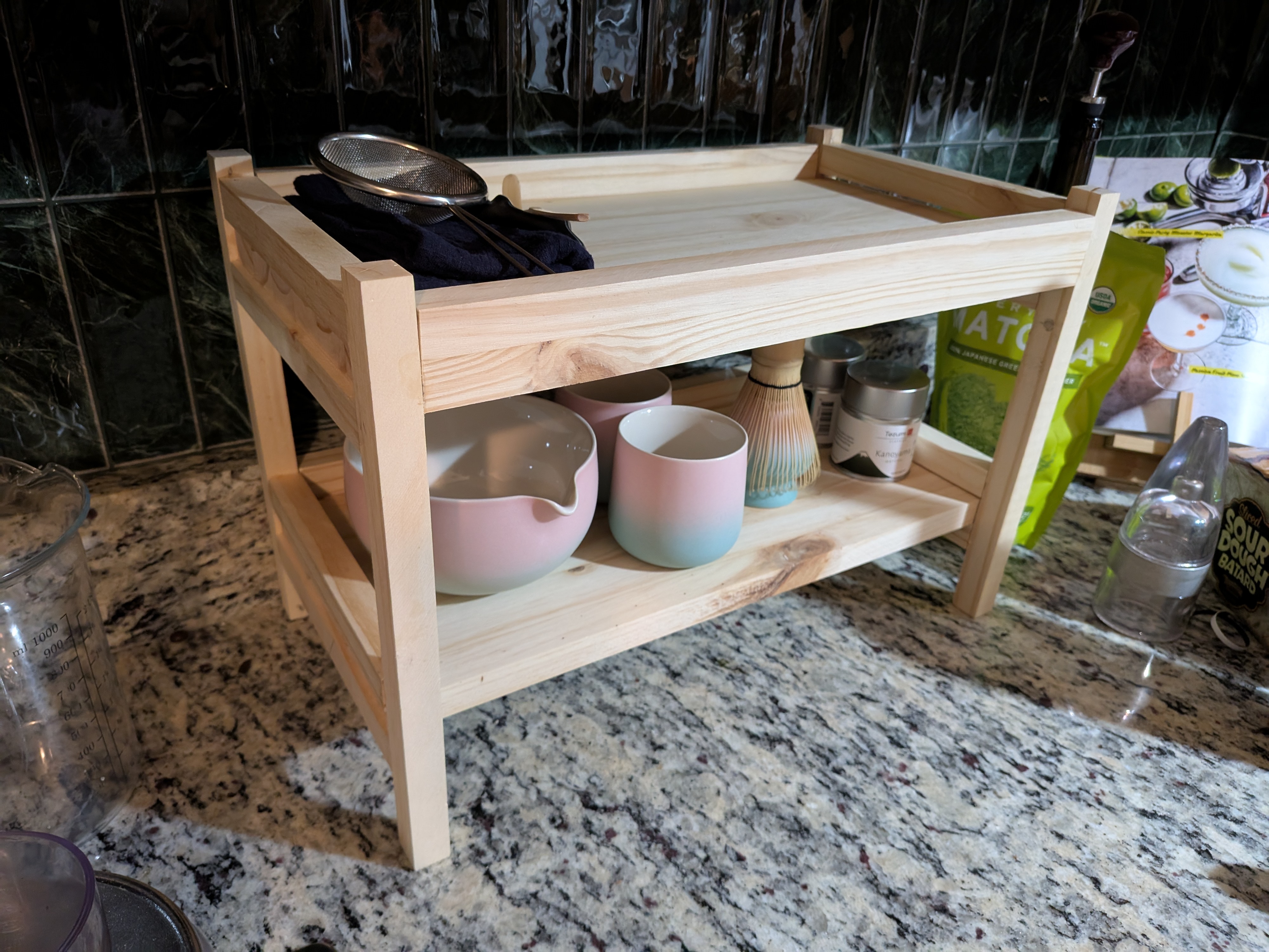 A wooden stand with a bunch of tea junk on it